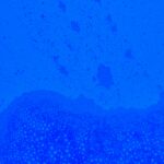 A vibrant abstract blue texture featuring an intricate pattern of bubbles, ideal for backgrounds and wallpapers.